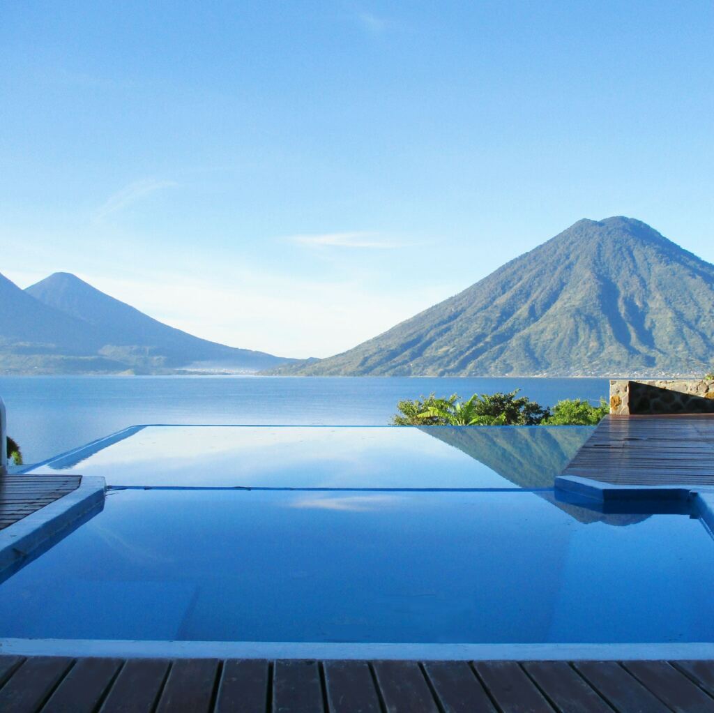 A serene blend of azul - jacuzzi, pool and lake, melting into the sky.